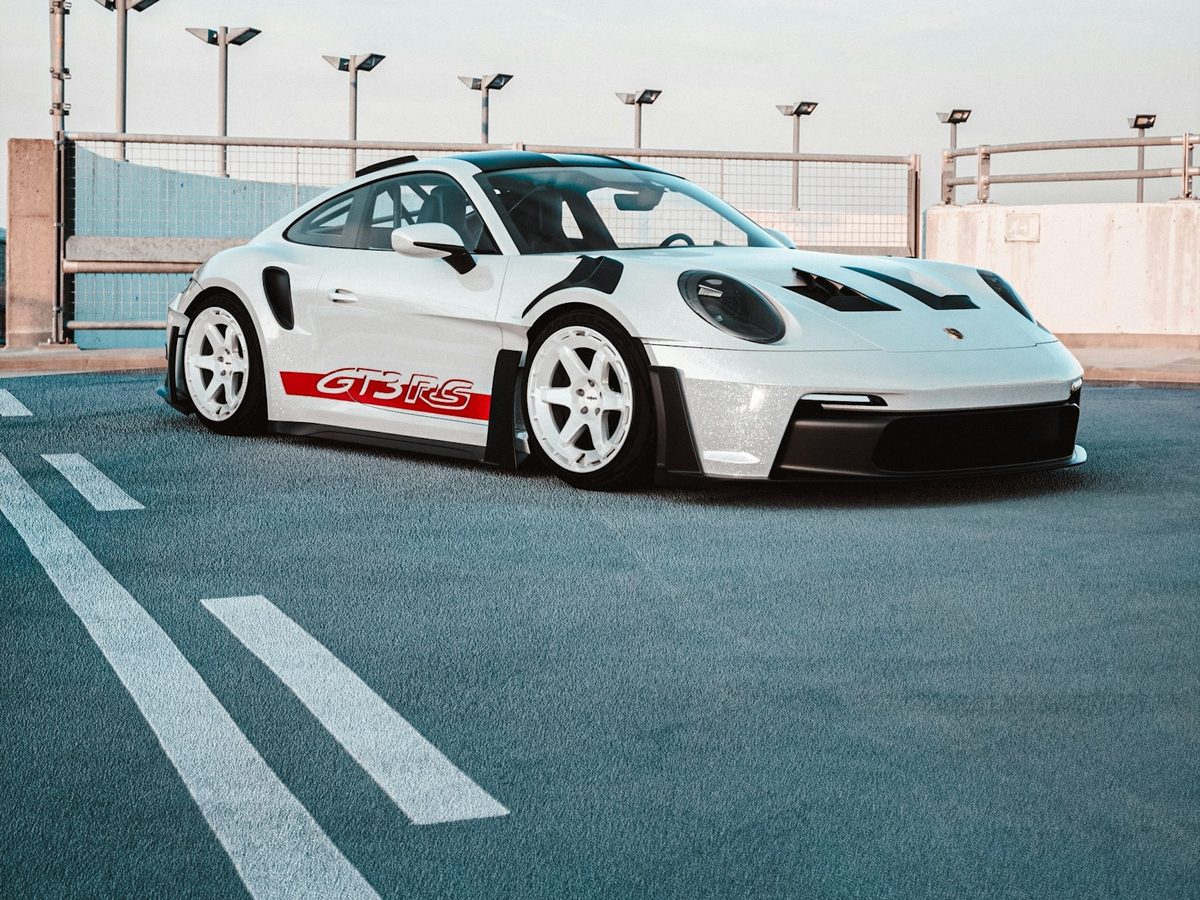 A white track-focused sports car parked on a rooftop